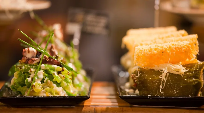 Two elaborate pintxos plated at a San Sebastian bar on the Devour pintxos and wine tour